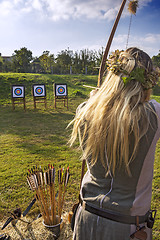 Image showing Medieval woman archer shoot at a target