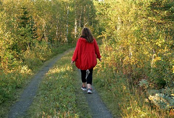 Image showing Woman walking on a dirt road