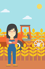 Image showing Woman standing with combine on background.