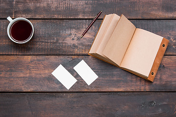 Image showing Office desk table with cup, notebook, cards on wooden table