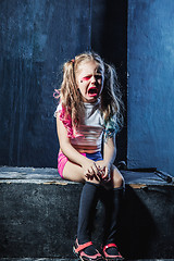 Image showing The crying crasy girl on dark background