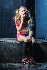 Image showing The crying crasy girl on dark background
