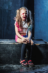 Image showing The crying crasy girl on dark background