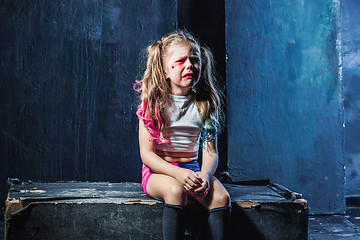 Image showing The crying crasy girl on dark background