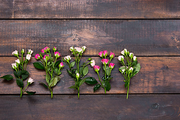 Image showing The wooden table with roses, top view