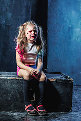 Image showing The crying crasy girl on dark background