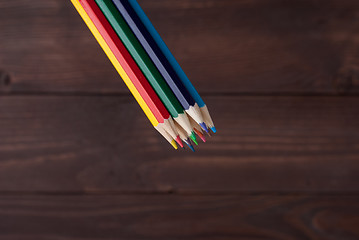 Image showing Colored pencils on a wooden board