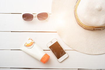 Image showing Beach accessories on wooden board