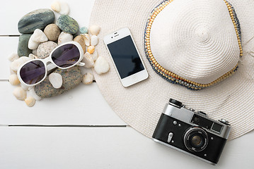 Image showing Beach accessories on wooden board