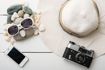 Image showing Beach accessories on wooden board