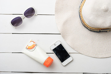 Image showing Beach accessories on wooden board