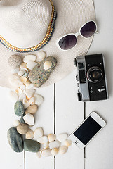 Image showing Beach accessories on wooden board