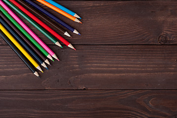 Image showing Colored pencils on a wooden board