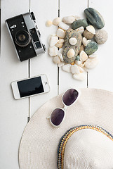 Image showing Beach accessories on wooden board