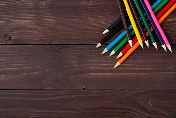 Image showing Colored pencils on a wooden board