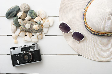 Image showing Beach accessories on wooden board