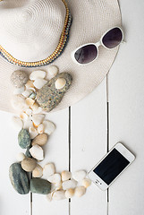 Image showing Beach accessories on wooden board