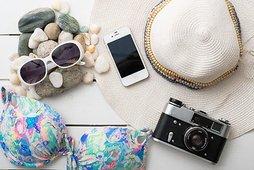 Image showing Beach accessories on wooden board