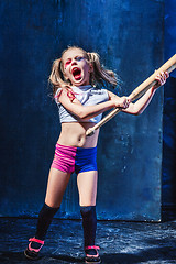 Image showing Halloween theme: Girl with baseball bat ready to hit