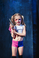 Image showing Little girl pointing in toy gun