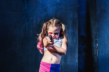 Image showing Little girl pointing in toy gun