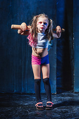 Image showing Little girl pointing in toy gun