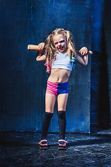 Image showing Little girl pointing in toy gun