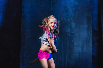 Image showing Little girl pointing in toy gun