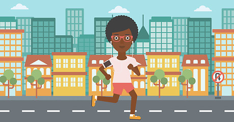 Image showing Woman running with earphones and smartphone.