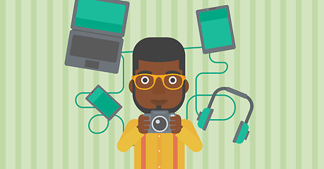 Image showing Young man surrounded with his gadgets.