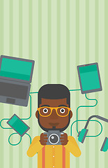 Image showing Young man surrounded with his gadgets.
