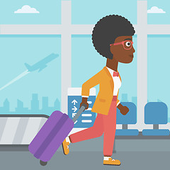 Image showing Woman walking with suitcase at the airport.