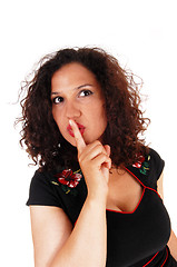 Image showing Woman whit finger over mouth.