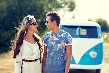 Image showing smiling young hippie couple over minivan car