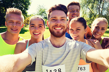 Image showing happy friends taking selfie with smartphone