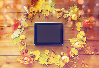 Image showing tablet pc with autumn leaves, fruits and berries