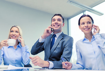 Image showing business team with smartphones having conversation