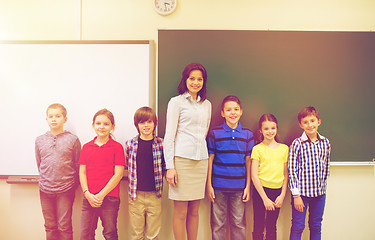 Image showing group of school kids and teacher in classroom