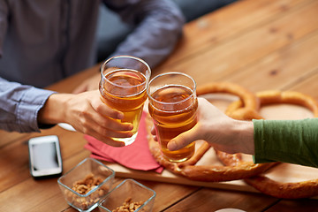 Image showing close up of hands clinking beer at bar or pub