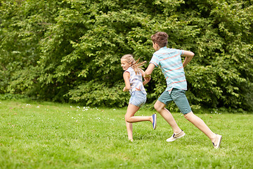 Image showing happy kids running and playing game outdoors