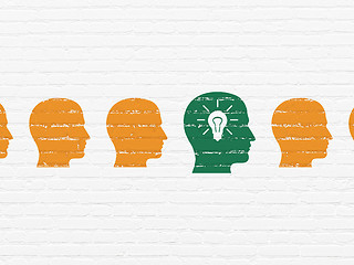 Image showing Business concept: head with light bulb icon on wall background