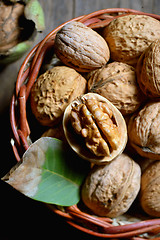 Image showing Walnut in basket on rustic old wood