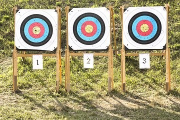 Image showing Three of paper archery targets in wooden stands 