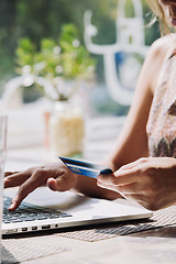 Image showing woman using laptop with credit card in hand