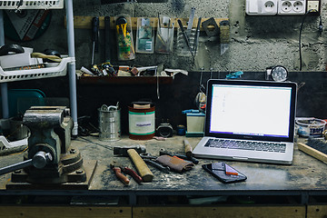 Image showing View of old tools,laptop and phone on table