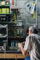 Image showing Senior mechanic working in garage