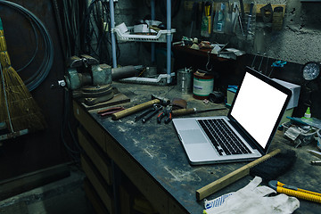 Image showing View of old tools,laptop and phone on table