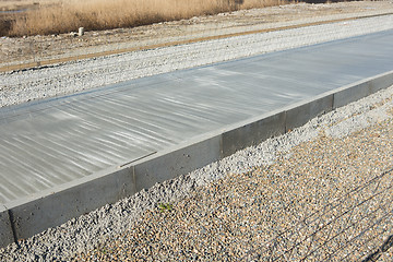 Image showing New concrete road barriers metal mesh