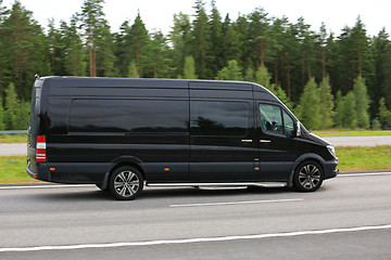 Image showing Black Mercedes-Benz Van at Speed