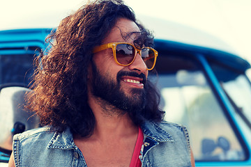 Image showing smiling young hippie man over minivan car